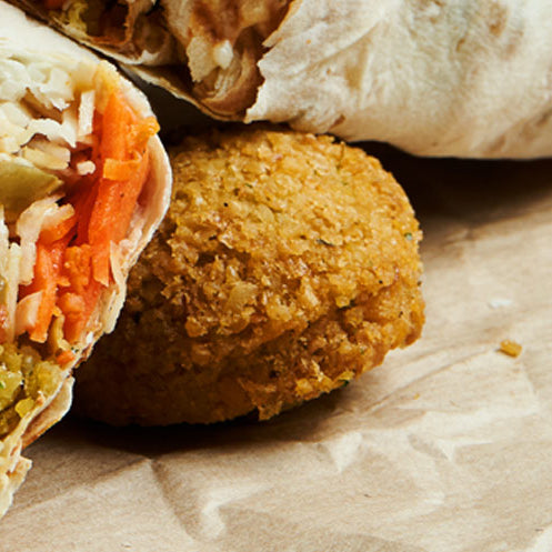 Shawarma chicken with Greek salad, flatbread, and homemade falafels